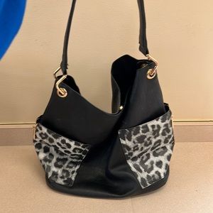Black with Leopard Print pockets Purse. It has no inside pockets.
